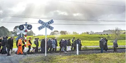  ?? WARWICK SMITH/STUFF ?? Nga¯ti Kauwhata kauma¯tua Kevin Emery leads a group in blessing the site where a train and bus collided on Wednesday near Palmerston North.