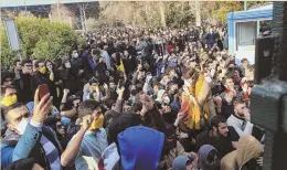  ?? AP PHOTO ?? SEEKING CHANGE: University students attend a protest inside Tehran University Saturday. Thirteen people have been killed.