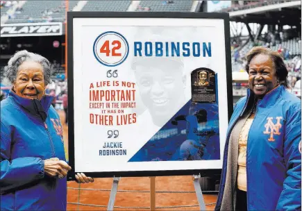  ?? Kathy Willens The Associated Press ?? Rachel Robinson, left, widow of Jackie Robinson, the first African-american in the major leagues, and daughter Sharon with a plaque honoring Jackie on Jackie Robinson Day before the Brewers-mets game on Sunday at Citi Field in New York.