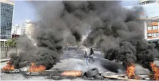  ??  ?? Anti-government protesters burn tyres during ongoing protests after weeks of calm in Beirut, Lebanon, yesterday. | AP