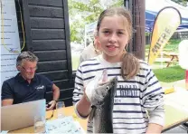  ?? PHOTO: KERRIE WATERWORTH ?? Hard to catch . . . Sarah Dougherty (12), of Wanaka, holds the 716g brown trout that did not get away.