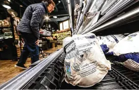  ?? JIM NOELKER/STAFF ?? Shoppers peruse the selection of fresh turkeys at the Dorothy Lane Market in Oakwood on Friday morning.