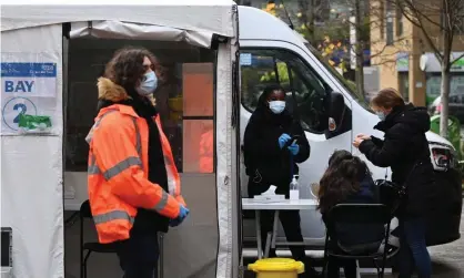  ?? Photograph: Andy Rain/EPA ?? A mobile PCR test centre in London. The Zoe study estimates that one in 32 people in the UK currently have symptomati­c Covid.