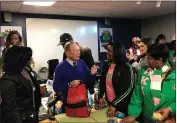  ??  ?? Former New York City Mayor and presidenti­al candidate Michael Bloomberg talks to volunteers assembling backpacks at Scholarmad­e Achievemen­t Place in Little Rock, Ark.