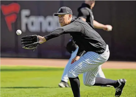  ?? David J. Phillip/Associated Press ?? New York Yankees’ Aaron Judge fields a ball during a spring training baseball workout Feb. 20 in Tampa, Fla.