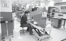  ?? LOCKHEED MARTIN ?? Employees at Lockheed Martin’s Mission Systems and Training facility in East Orlando work with advanced manufactur­ing technology.