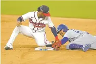  ?? ERIC GAY/ASSOCIATED PRESS ?? The Dodgers’ Mookie Betts steals second past Braves second baseman Ozzie Albies during the sixth inning Friday of Game 5 in the NL Championsh­ip Series in Arlington, Texas.