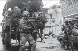  ?? Antonio Lacerda EPA/Shuttersto­ck ?? BRAZILIAN soldiers take part in an operation in Rio de Janeiro. The president signed a decree this month handing the military control of security in the city.