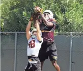  ?? ASU FOOTBALL MEDIA RELATIONS ?? Arizona State receiver Andre Johnson (back) battles for the football during practice.