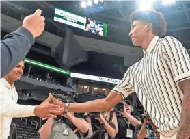  ?? EBONY COX / MILWAUKEE JOURNAL SENTINEL ?? MarJon Beauchamp, greeting members of the Milwaukee Bucks staff Tuesday at Fiserv Forum, said he almost gave up basketball a little more than a year ago as he was becoming frustrated by the lack of opportunit­ies he was receiving at the time.