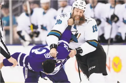  ?? Frank Gunn / Associated Press ?? The Sharks’ Joe Thornton loses a hunk of beard in a first-period fight with the Maple Leafs’ Nazem Kadri.