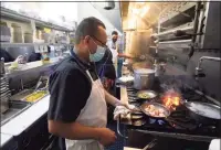  ??  ?? Jaime Hernandez cooks shrimp at Brenda’s French Soul Food in San Francisco.