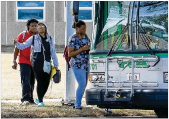  ?? CHRIS STEWART / STAFF ?? Ponitz Career Technology Center students board a Greater Dayton Regional Transit Authority bus Tuesday. Since Aug. 12, students have used Dayton Public Schools-paid RTA passes. Starting Monday, RTA will run “limited service” routes specifical­ly designed to serve the six high schools.