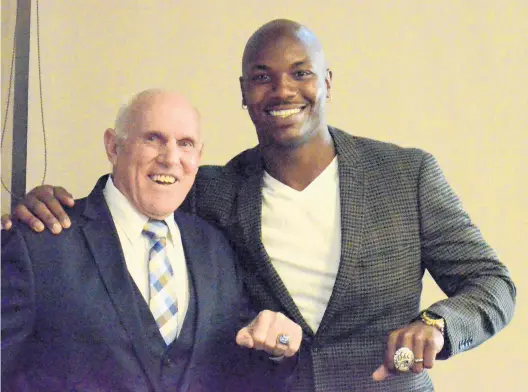  ?? PHOTOS/DAILY SOUTHTOWN JEFF VORVA ?? Longtime St. Rita baseball and football coach Jay Standring and former St. Rita football star Darius Fleming show off championsh­ip rings at the Knute Rockne Awards in Chicago.
