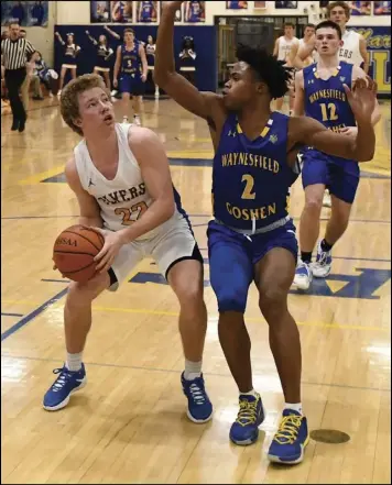  ?? Photo by John Zwez ?? Za’mere daniel of Waynesfiel­d-goshen, right, defends as Marion Local’s peyton otte prepares to go up for a shot during Wednesday’s division IV sectional playoff game.