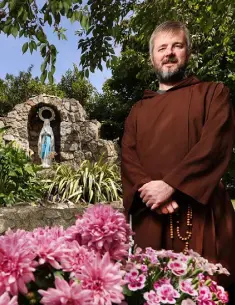  ??  ?? CHALLENGES: Fr Bryan Shortall in the grounds of Saint Francis of Assisi parish in Priorswood, Dublin. Photo: Steve Humphreys