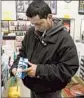  ?? Gary Friedman
Los Angeles Times ?? A CUSTOMER inspects a prepaid Samsung phone in Los Angeles.