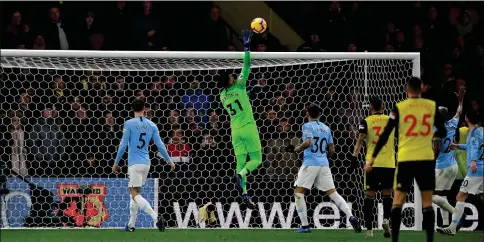  ?? — AFP photo ?? Manchester City’s Brazilian goalkeeper Ederson (C) tips the ball over the bar to make a last minute save during the English Premier League football match between Watford and Manchester City at Vicarage Road Stadium in Watford, north of London.