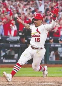  ?? JEFF CURRY-USA TODAY SPORTS ?? St. Louis Cardinals infielder Kolten Wong scores on an RBI sacrifice fly hit by Yadier Molina in the 10th inning to defeat the Atlanta Braves in Game 4 of their best-of-five series Monday.