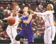  ?? Steve Cannon / Associated Press ?? Buffalo’s Stephanie Reid cuts between Florida State’s Chatrice White, left, and AJ Alix as she attempts a shot in the Bulls’ 86-65 victory in Tallahasse, Fla., on Monday.