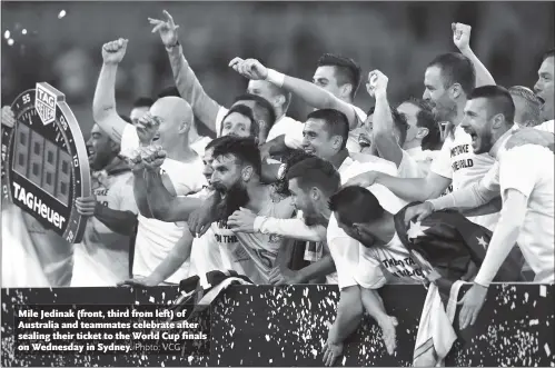  ??  ?? Mile Jedinak (front, third from left) of Australia and teammates celebrate after sealing their ticket to the World Cup finals on Wednesday in Sydney.