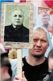  ?? OLEG NIKISHIN GETTY IMAGES ?? People carry portraits of their relatives — Second World War soldiers — as they take part in the Immortal Regiment march Monday in Moscow.