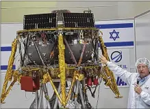  ?? ILAN BEN ZION ?? Opher Doron, general manager of Israel Aerospace Industries’ space division, shows the SpaceIL lunar module Tuesday in a “clean room” on a media tour of the facility near Tel Aviv, Israel.