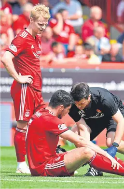  ?? Picture: SNS. ?? A painful moment for Scott McKenna against Rangers, watched by Gary Mackay-Steven.