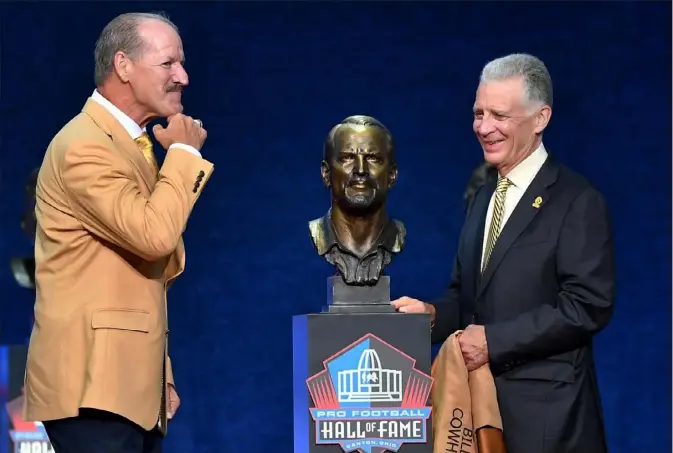  ?? ON THE WEB: visit post-gazette.com. Matt Freed/Post-Gazette photos ?? Bill Cowher compares the chin on his bust with the real thing Saturday night after Steelers president Art Rooney II unveiled Cowher’s Hall of Fame bust in ceremonies at Tom Benson Hall of Fame Stadium in Canton, Ohio. For more photos from Saturday night’s ceremony,