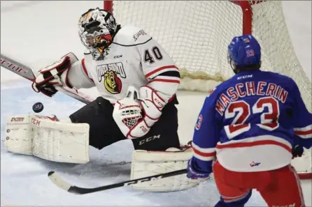  ?? MATHEW MCCARTHY, RECORD STAFF ?? Kitchener Rangers’ Adam Mascherin watches Owen Sound Attack goalie Michael McNiven handle a shot in the first period.