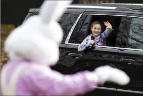  ?? CHRISTOPHE­R DOLAN ?? A girl waves to the Easter Bunny from her family’s car as they travel past the Waverly Community House in Waverly Twp., Pa., Saturday, April 4, 2020. With the Waverly Community House’s annual Breakfast with the Bunny event cancelled due to the COVID-19 outbreak, children were given the opportunit­y to wave to the Easter Bunny from a safe distance while staying in their cars.