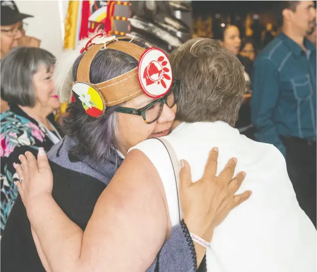  ?? STEPHEN MACGILLIVR­AY / THE CANADIAN PRESS ?? Roseanne Archibald of the Taykwa Tagamou Nation in Ontario, who has become the first woman to serve as national chief of the Assembly of First Nations, receives a hug after the closing ceremony of the AFN’S Annual General Assembly in Fredericto­n, N.B., on Thursday.