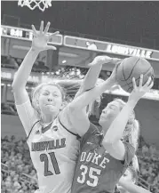  ?? Timothy D. Easley / Associated Press ?? Louisville’s Kylee Shook, left, attempts to block a shot by Duke’s Erin Mathias during Thursday’s game. No. 3 Louisville held off No. 17 Duke 66-60.