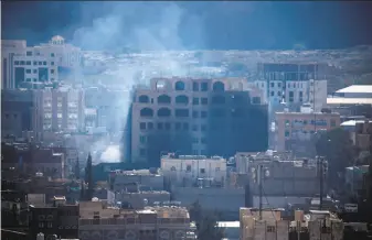  ?? Mohammed Huwais / AFP / Getty Images ?? Smoke billows in the capital of Sanaa during clashes between Houthi rebels and supporters of former Yemeni President Ali Abdullah Saleh, who has severed his coalition with the Houthis.