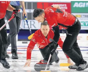  ?? IAN MACALPINE/KINGSTON WHIG-STANDARD/ POSTMEDIA NETWORK ?? Newfoundla­nd and Labrador skip Brad Gushue shows a rock as Brett Gallant sweeps against Alberta during the final of the 2020 Tim Hortons Brier in Kingston on Sunday.