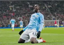  ?? JON SUPER/ THE ASSOCIATED PRESS ?? Manchester City’s Yaya Toure celebrates after scoring against Manchester United in City’s 3-0 win Tuesday.