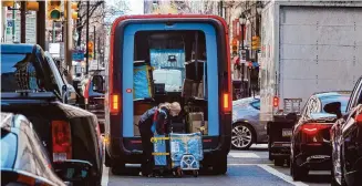  ?? Alejandro A. Alvarez/Tribune News Service ?? An Amazon delivery person takes packages out of her truck on Chestnut Street in Philadelph­ia. Some consumers say they can’t break their Amazon shopping habit, despite having ethical concerns.