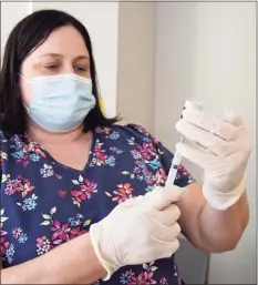  ?? H John Voorhees III / Hearst Connecticu­t Media ?? Registered nurse Alysa Irizarry, of the Greater Danbury Community Health Center, prepares a COVID-19 vaccinatio­n last month.