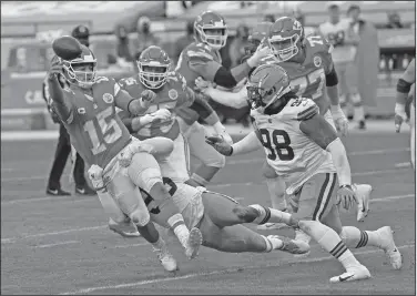  ?? Associated Press ?? On the move: Kansas City Chiefs quarterbac­k Patrick Mahomes (15) throws a pass in front of Cleveland Browns defensive tackle Sheldon Richardson, right, during the second half of an NFL divisional round football game Sunday in Kansas City. The Chiefs take on Buffalo in the AFC Championsh­ip game.