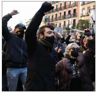  ?? (AP/Paul White) ?? People at El Rastro flea market in Madrid protest Sunday against restrictio­ns imposed by authoritie­s during the pandemic. The centuries-old flea market reopened Sunday after a contentiou­s eight-month closure because of covid-19.