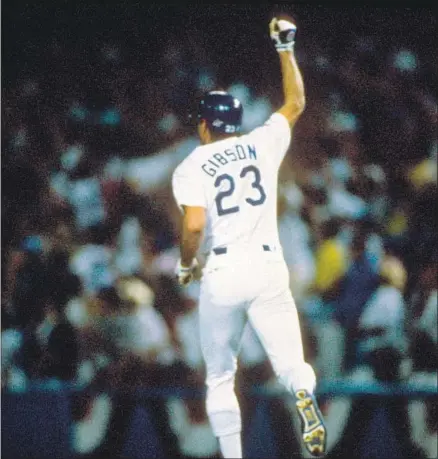  ?? Focus On Sport Getty I mages ?? KIRK GIBSON hobbles around the bases after hitting a game- winning, pitch- hit home run in the bottom of the ninth inning of Game 1 of the 1988 World Series against the Oakland Athletics. The legendary moment led the Dodgers to their last Series title.