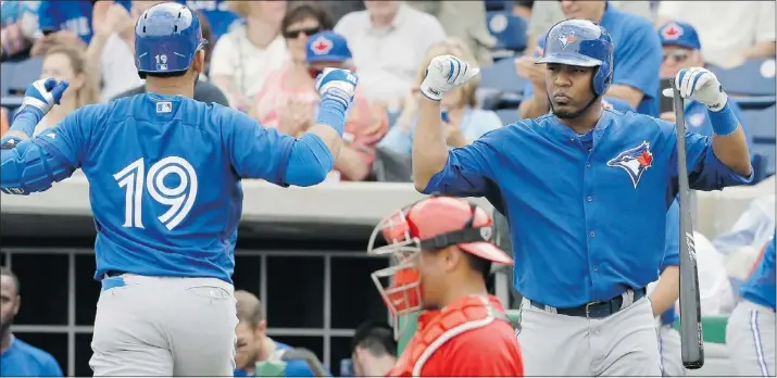  ?? — THE ASSOCIATED PRESS ?? Toronto Blue Jays’ Jose Bautista, left, is greeted by Edwin Encarnacio­n after hitting a home run during the first inning Wednesday in Clearwater, Fla.