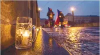  ??  ?? Protesters built a chain of beer glasses containing lit candles in central Prague to challenge restrictio­ns adopted to combat the Covid-19 spread.