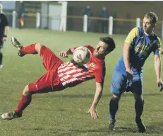  ??  ?? Ryhope CW’s Kyle Davis goes for a spectacula­r effort at Jarrow Roofing