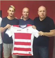  ?? (Granada website) ?? OMER ATZILI (left) poses yesterday with a shirt of La Liga club Granada CF with his agents Ronen and Gilad Katzav after completing his move to the Spanish club.