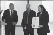  ??  ?? Lucinia Mundy, right, of the Charles County Department of Economic Developmen­t, accepted a Governor’s Citation on behalf of Guy Black of Blackout Investigat­ions and Security Services of Waldorf from Herbert Jordan III, deputy secretary of the...