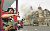  ?? AP FILE ?? A soldier takes cover as a gun battle with terrorists rages at the Taj n
Mahal hotel, Mumbai, on November 29, 2008.