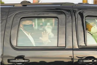  ?? Alex Edelman / AFP / Getty Images ?? Above: President Trump waves to supporters during last Sunday’s motorcade outside Walter Reed hospital in Bethesda, Md.