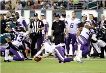  ?? AP Photo/Michael Perez ?? ■ Minnesota Vikings’ Stefon Diggs recovers an onside kick during the second half against the Philadelph­ia Eagles on Oct. 7 in Philadelph­ia. Onside kicks have always been a bad bet, but not like this. Thanks to the NFL’s rules changes on kickoffs that were designed to reduce the risk of concussion­s, successful onside kicks have nearly disappeare­d from the game.