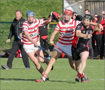  ??  ?? Oulart-The Ballagh’s Michael Jacob clashes with Eoin Murphy (8) and Paul Morris (14) of Ferns-St. Aidan’s.